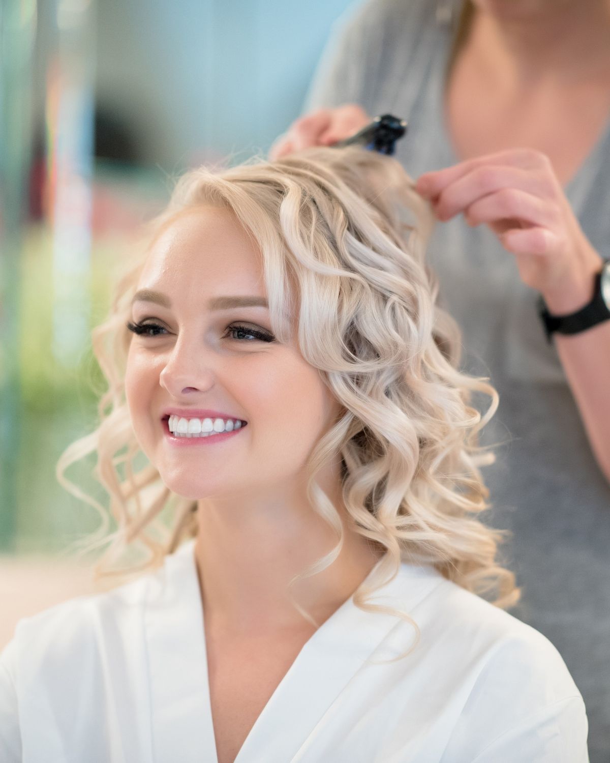 A stylist finishing a client’s hair in the salon